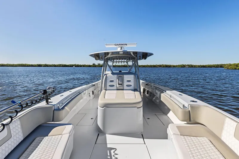 Slide: The Image of 2022 Contender 44 CB boat on calm water, featuring spacious seating and Garmin equipment. - 14