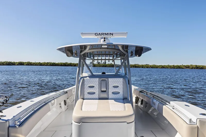 Slide: The Image of 2022 Contender 44 CB boat on water, featuring Garmin equipment and luxurious seating. - 15