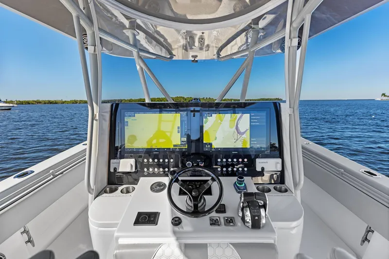 Slide: The Image of 2022 Contender 44 CB boat cockpit with advanced navigation system on open water. - 17