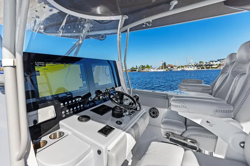 Slide: The Image of 2022 Contender 44 CB boat cockpit with advanced navigation system and luxurious seating. - 18
