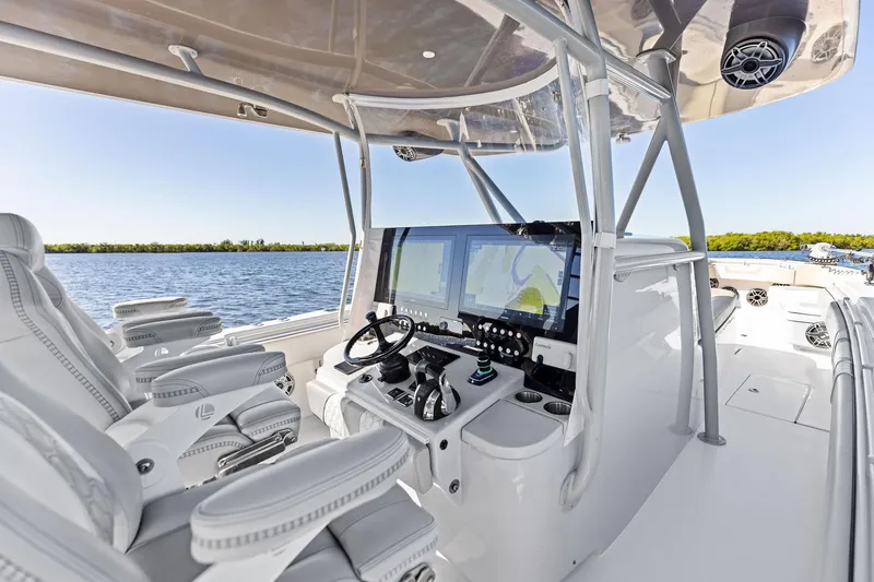 Slide: The Image of 2022 Contender 44 CB boat cockpit with advanced navigation system and luxurious seating. - 19