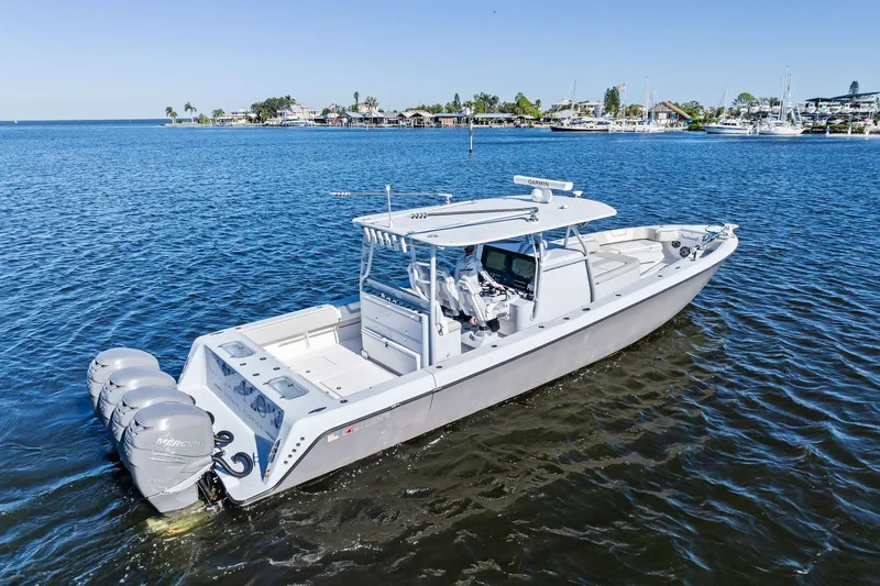 Slide: The Image of 2022 Contender 44 CB boat on calm blue water, featuring triple Mercury engines. - 2