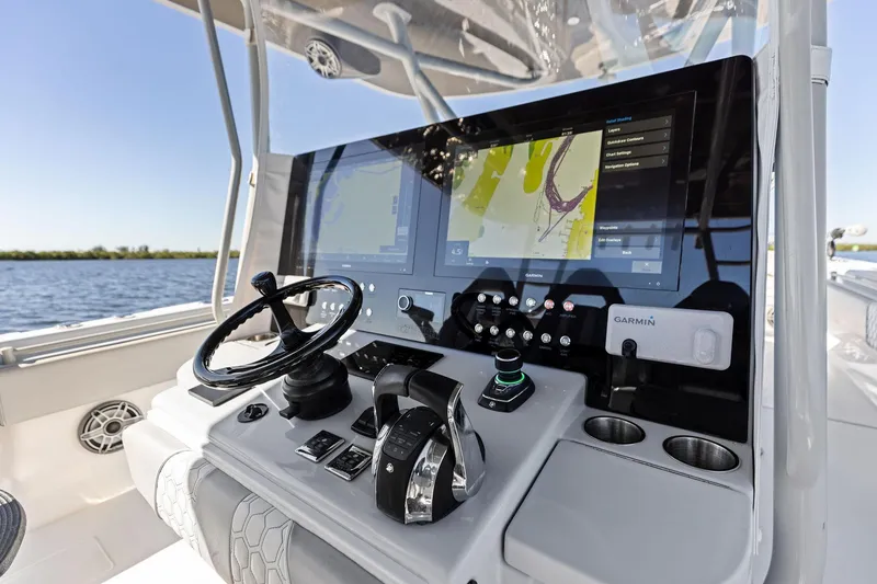 Slide: The Image of 2022 Contender 44 CB boat dashboard with Garmin navigation system and steering wheel. - 20