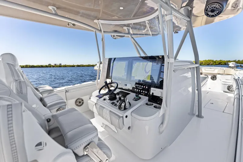 Slide: The Image of 2022 Contender 44 CB boat cockpit with advanced navigation system and luxurious seating. - 21