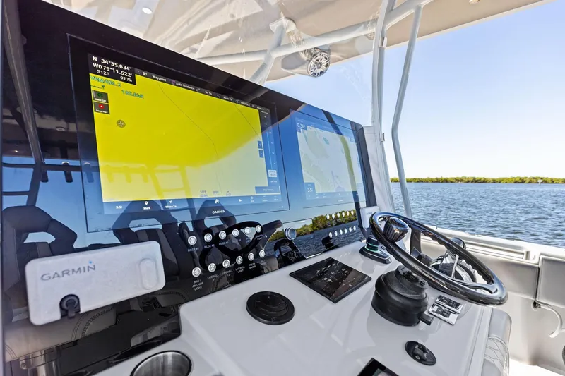 Slide: The Image of 2022 Contender 44 CB boat dashboard with Garmin navigation system on open water. - 22