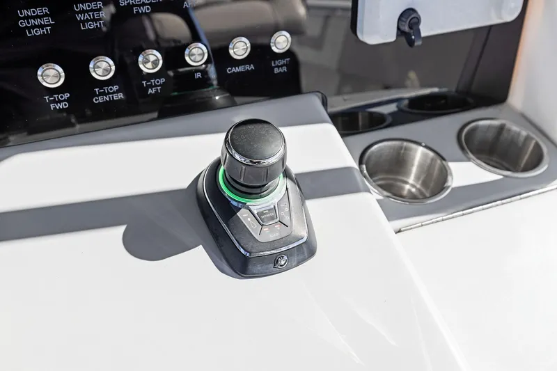 Slide: The Image of 2022 Contender 44 CB boat control panel with joystick and cup holders. - 24