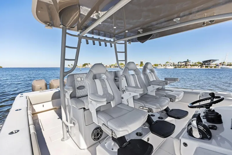 Slide: The Image of Contender 44 CB 2022 boat interior with luxurious seating and ocean view. - 29
