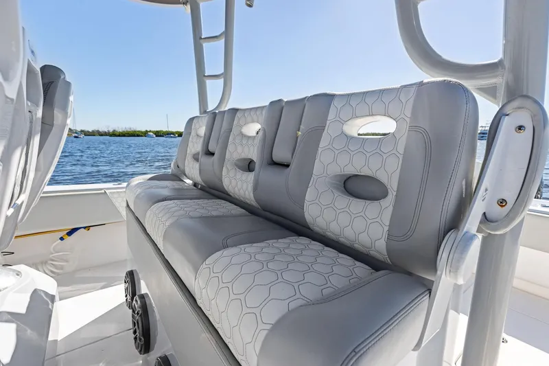 Slide: The Image of 2022 Contender 44 CB boat with stylish gray seating, on a sunny day by the water. - 32