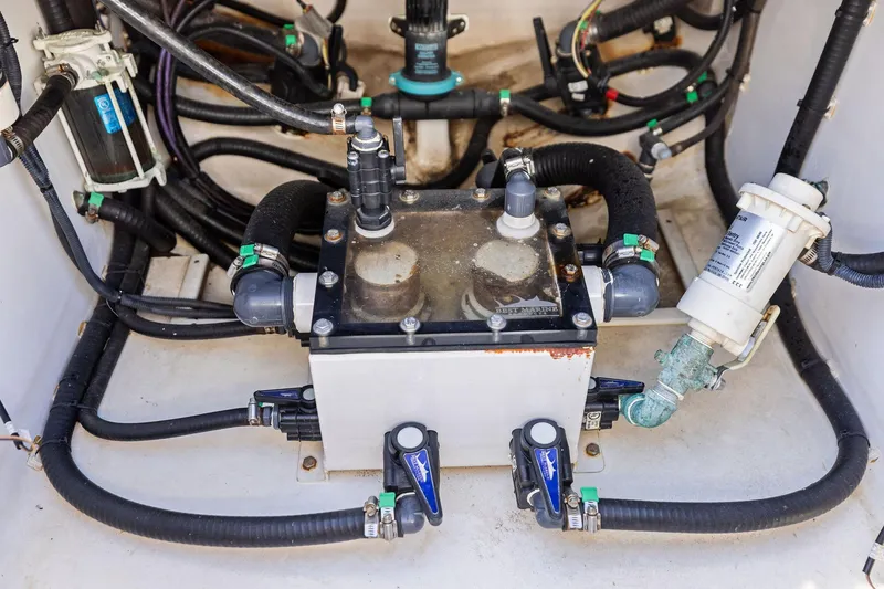 Slide: The Image of Engine compartment of 2022 Contender 44 CB boat with hoses and filters. - 37