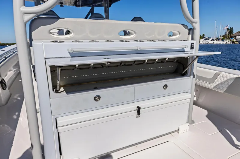 Slide: The Image of 2022 Contender 44 CB boat with open storage compartments and rod holders. - 39