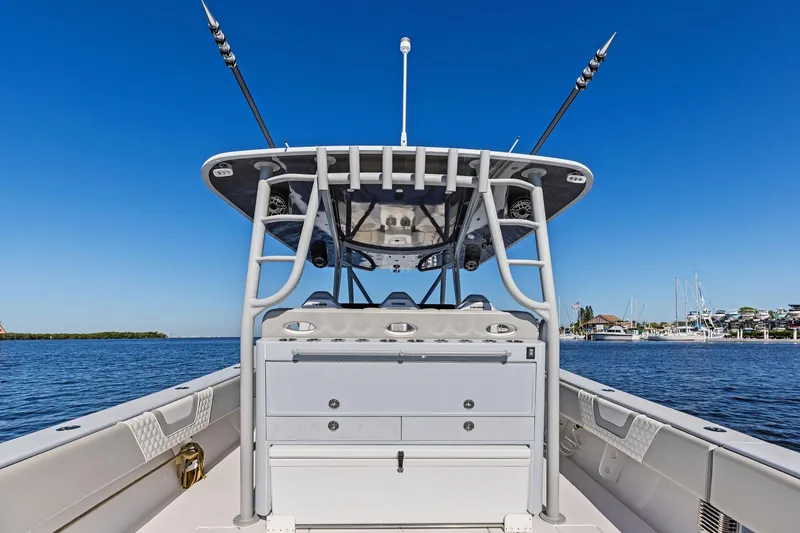 Slide: The Image of 2022 Contender 44 CB boat on water, featuring fishing rods and clear blue sky. - 40