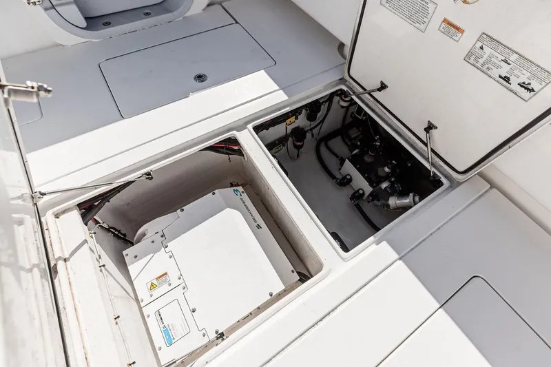 Slide: The Image of 2022 Contender 44 CB boat engine compartment with open hatches and visible equipment. - 42