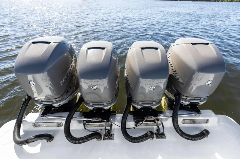 Slide: The Image of Four Mercury outboard engines on a 2022 Contender 44 CB boat, on water. - 44