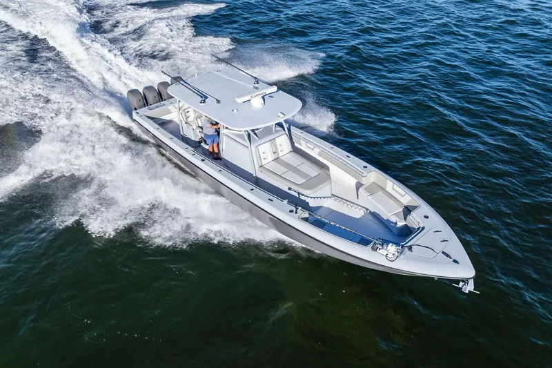 Slide: The Image of 2022 Contender 44 CB boat cruising on open water, showcasing sleek design and powerful engines. - 46
