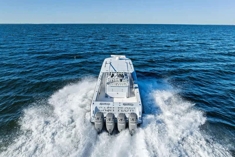 Slide: The Image of 2022 Contender 44 CB boat cruising on open ocean with four engines. - 47
