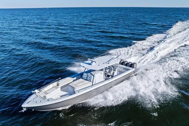 Slide: The Image of 2022 Contender 44 CB boat cruising on open ocean waters. - 51