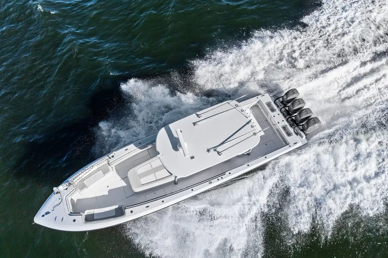 Slide: The Image of 2022 Contender 44 CB boat speeding on open water, aerial view. - 52