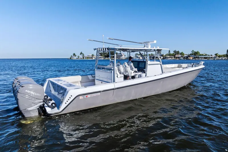 Slide: The Image of 2022 Contender 44 CB boat on water, featuring Mercury engines, clear blue sky. - 7