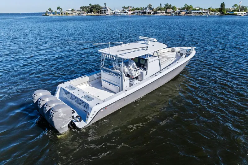 Slide: The Image of 2022 Contender 44 CB boat with triple outboard engines on open water. - 8