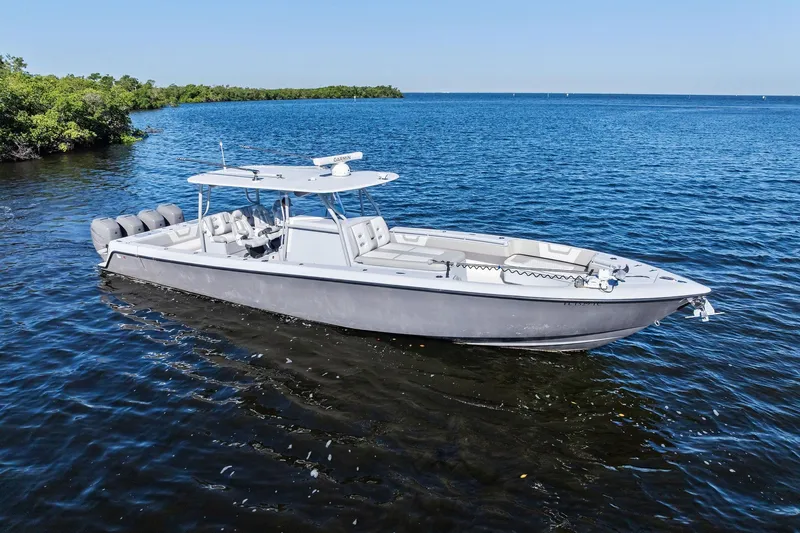 Slide: The Image of 2022 Contender 44 CB boat on calm blue water, featuring sleek design and multiple engines. - 9