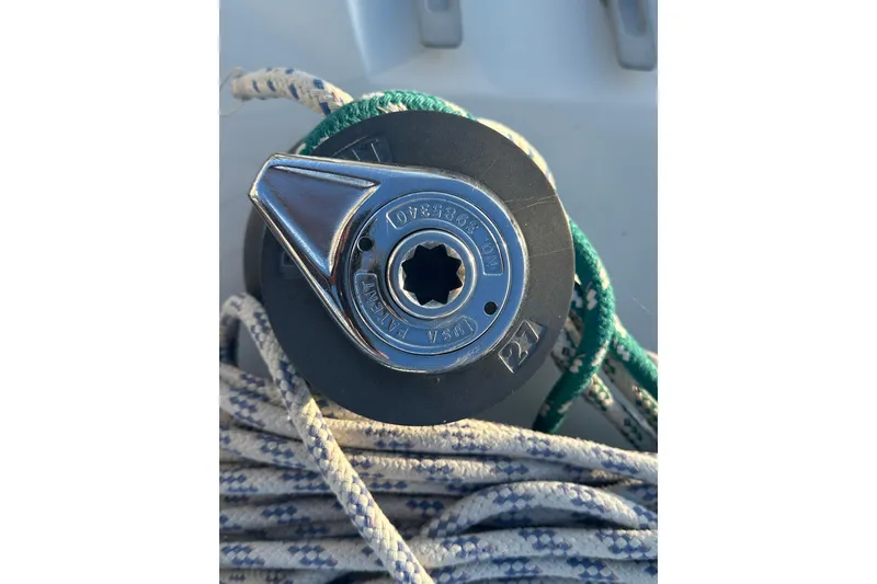 Slide: The Image of Winch handle on a 1984 C&C 41 sailboat, surrounded by coiled ropes. - 18