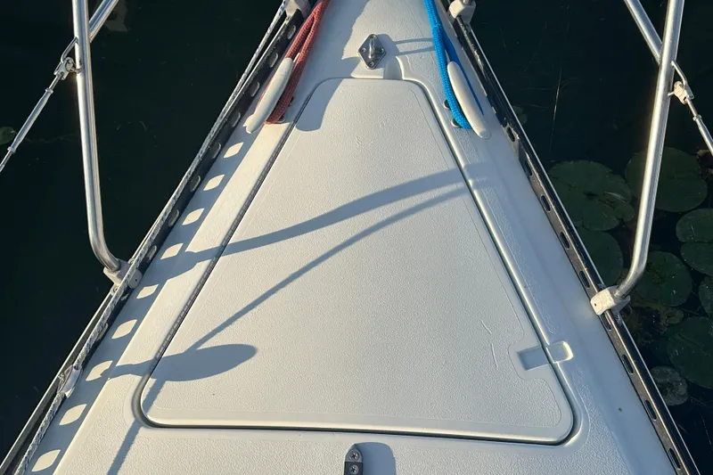 Slide: The Image of Bow of 1984 C&C 41 sailboat with ropes and metal railings. - 28