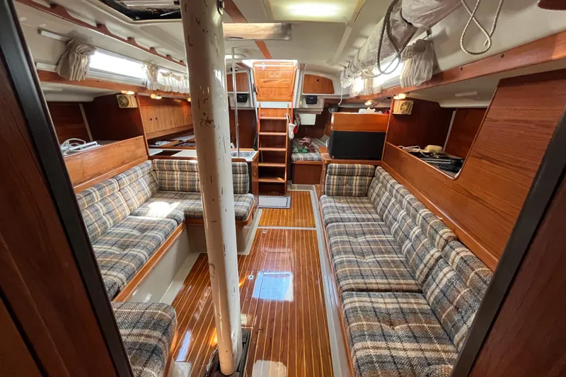 Slide: The Image of Interior of 1984 C&C 41 sailboat with plaid seating and wooden finishes. - 33