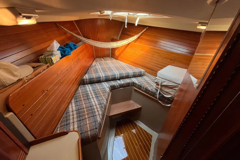 Slide: The Image of Cozy cabin interior of 1984 C&C 41 sailboat with wood paneling and plaid bedding. - 39