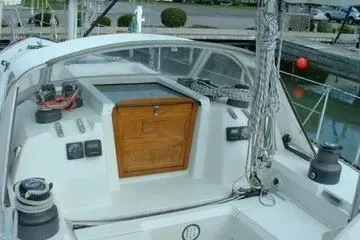 Slide: The Image of 1984 C&C 41 sailboat cockpit with wooden hatch, winches, and ropes at dock. - 4