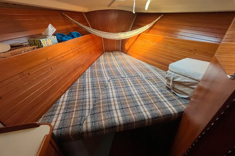 Slide: The Image of Cozy cabin interior of 1984 C&C 41 sailboat with plaid bedding and wooden paneling. - 40