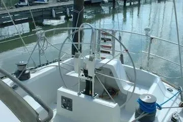 Slide: The Image of 1984 C&C 41 sailboat cockpit with steering wheel and marina view. - 5