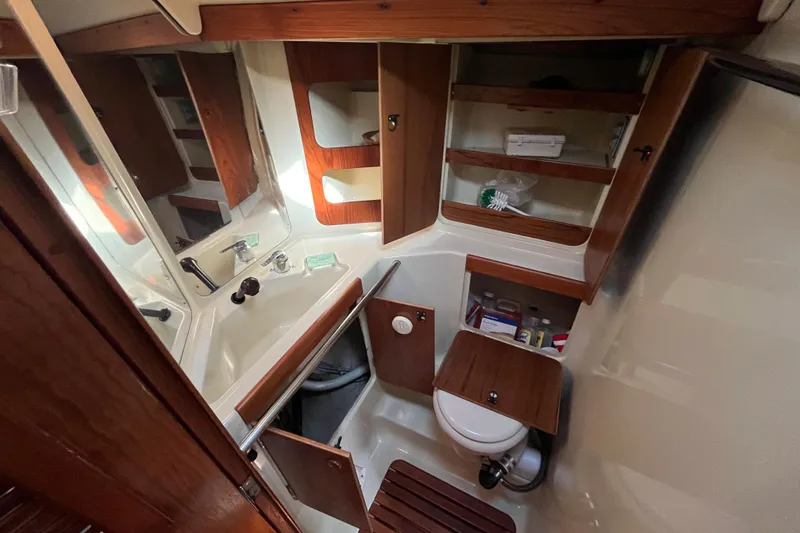 Slide: The Image of 1984 C&C 41 yacht bathroom with wooden cabinets and compact design. - 59