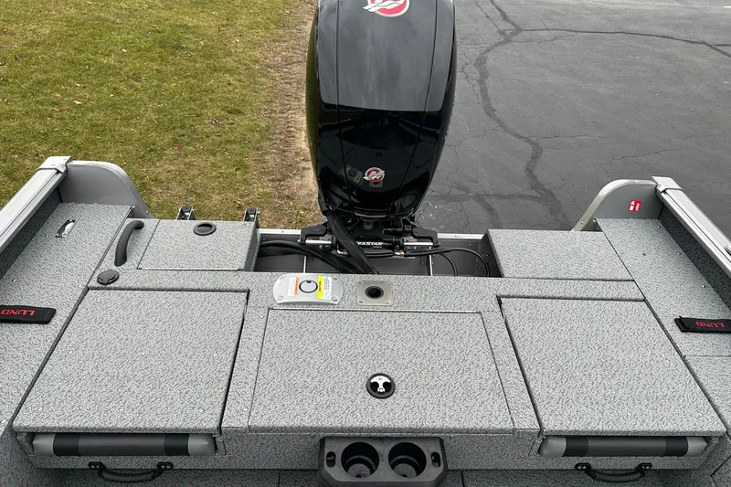 Slide: The Image of 2026 Lund 1875 Impact XS SS boat with motor, featuring a spacious deck layout. - 14