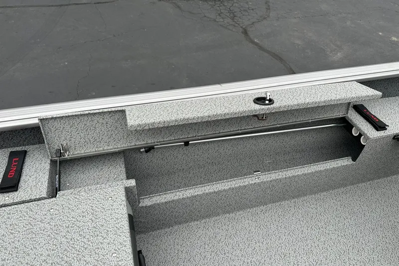 Slide: The Image of Interior view of 2026 Lund 1875 Impact XS SS boat, showcasing storage compartment and seating area. - 20