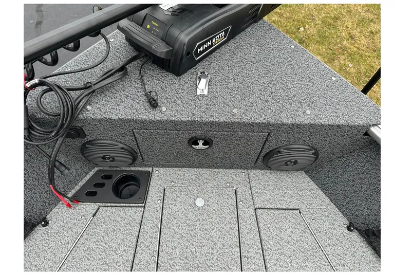 Slide: The Image of 2026 Lund 1875 Impact XS SS boat interior with Minn Kota trolling motor and speakers. - 21