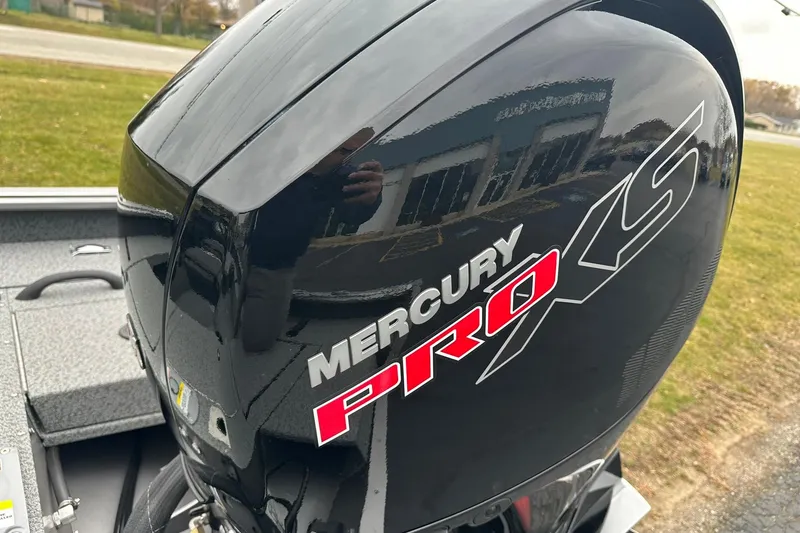 Slide: The Image of 2026 Lund 1875 Impact XS SS with Mercury Pro XS engine, outdoor setting. - 23