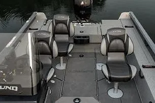 Slide: The Image of 2026 Lund 1875 Impact XS SS boat interior with steering console and seating. - 5