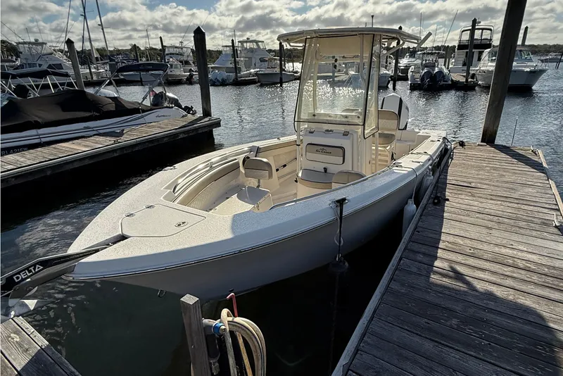 Slide: The Image of 2020 Sea Chaser 22 HFC boat docked at marina under cloudy sky. - 2
