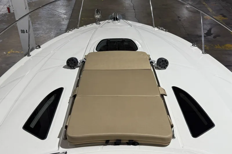 Slide: The Image of 2017 Sea Ray Sundancer 330 in a boat showroom, surrounded by various yachts. - 12