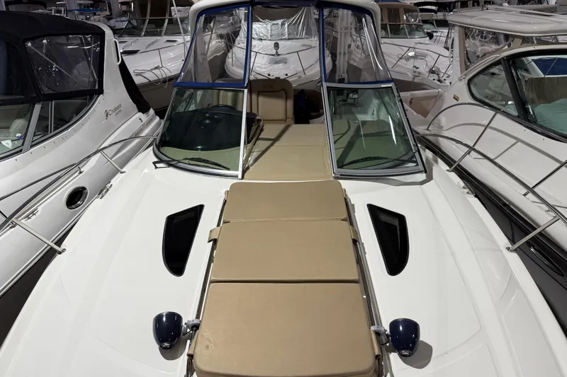 Slide: The Image of 2017 Sea Ray Sundancer 330 yacht in indoor storage, featuring sleek design and comfortable seating. - 13