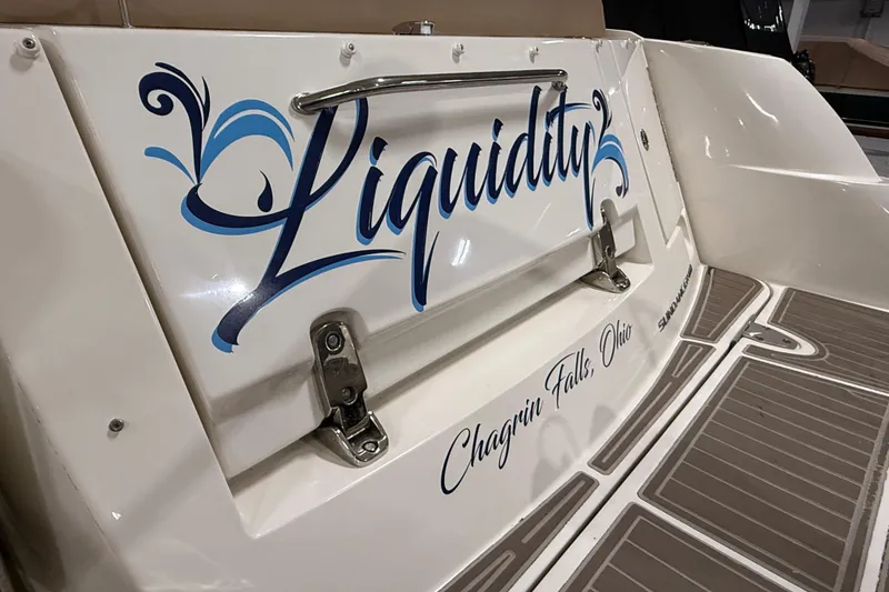 Slide: The Image of 2017 Sea Ray Sundancer 330 interior with seating and helm, showcased in a marina setting. - 17