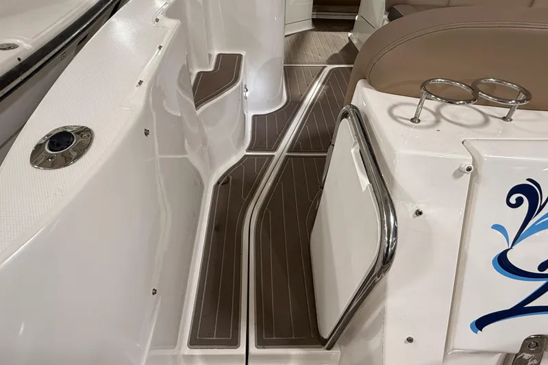 Slide: The Image of 2017 Sea Ray Sundancer 330 boat with tan seating and wood-patterned flooring. - 19