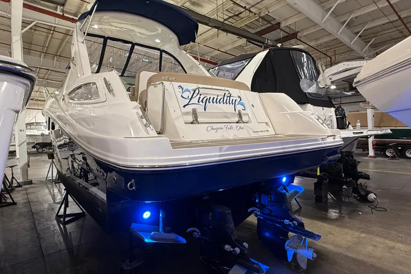 Slide: The Image of 2017 Sea Ray Sundancer 330 yacht in a warehouse, featuring blue underwater lights. - 2