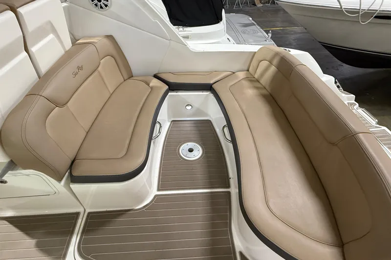 Slide: The Image of 2017 Sea Ray Sundancer 330 interior with seating, sink, and storage in a showroom. - 23