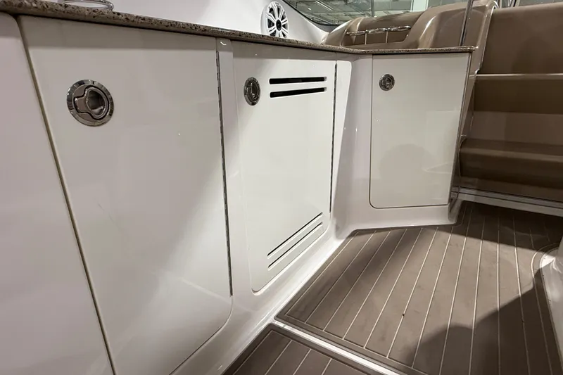 Slide: The Image of 2017 Sea Ray Sundancer 330 interior view with dashboard and windows in a showroom. - 29