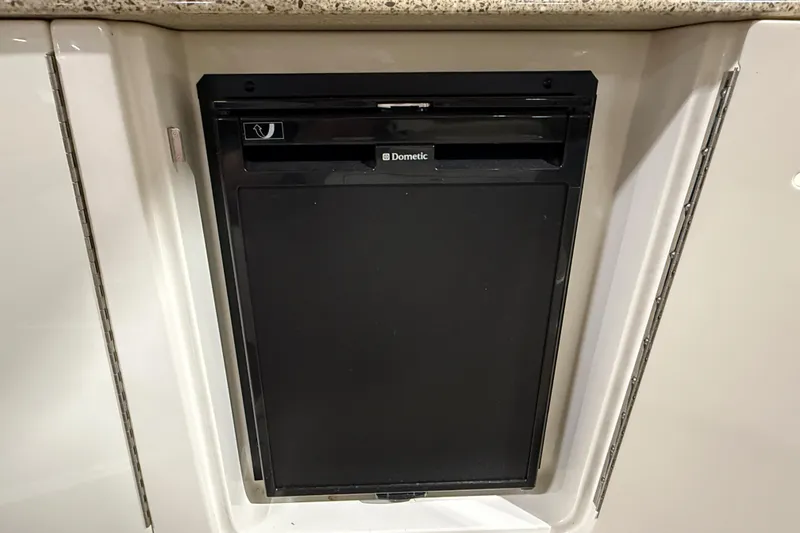 Slide: The Image of 2017 Sea Ray Sundancer 330 helm with navigation system and steering wheel in a showroom. - 30