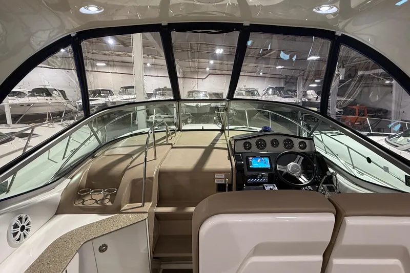 Slide: The Image of Luxurious seating on 2017 Sea Ray Sundancer 330 yacht, featuring beige upholstery and cup holders. - 31