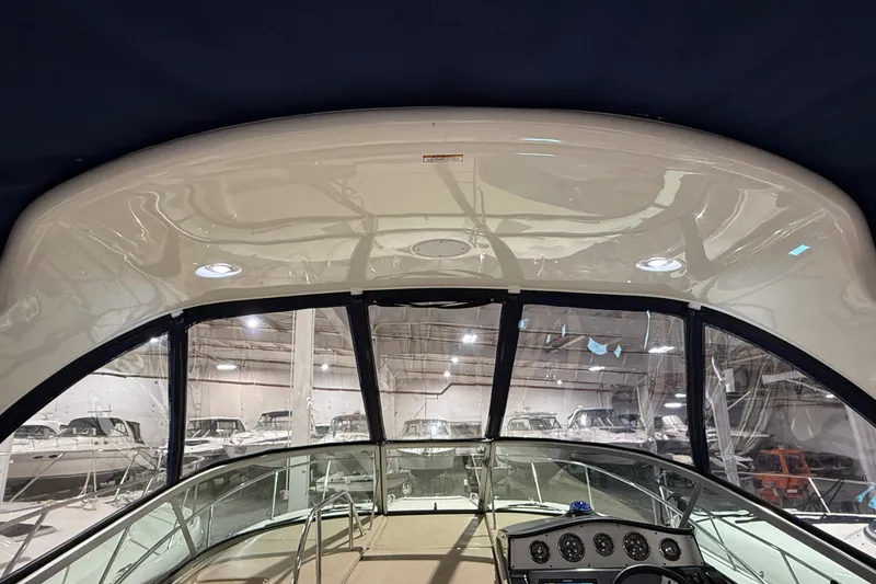 Slide: The Image of 2017 Sea Ray Sundancer 330 helm with steering wheel, gauges, and navigation display. - 32