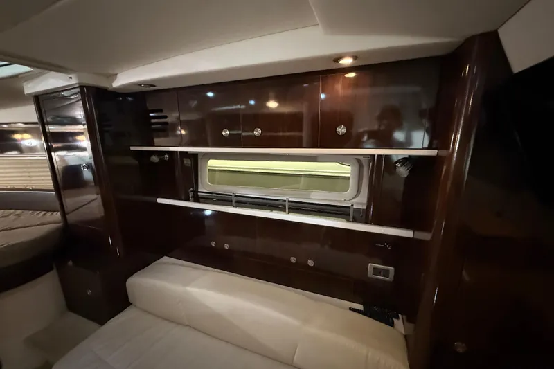 Slide: The Image of Luxurious interior of 2017 Sea Ray Sundancer 330 with elegant wood finishes and cozy bedding. - 47