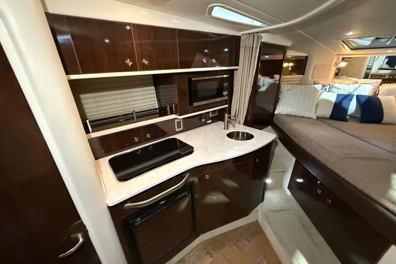 Slide: The Image of Open refrigerator inside 2017 Sea Ray Sundancer 330 yacht, showcasing interior storage space. - 54